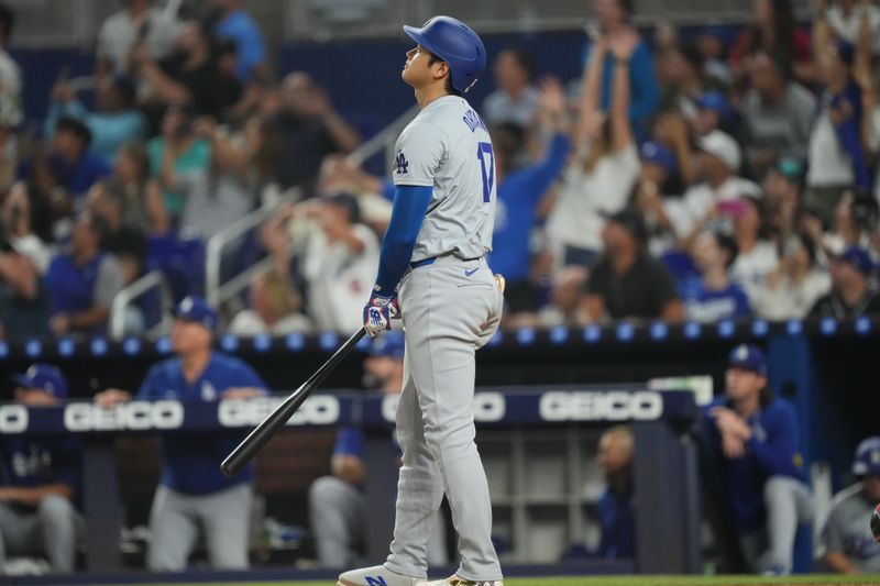 Sep 17, 2024; Miami, Florida, USA;  Los Angeles Dodgers designated hitter Shohei Ohtani (17) watches his two-run home run in the third inning against the Miami Marlins at loanDepot Park. Mandatory Credit: Jim Rassol-Imagn Images