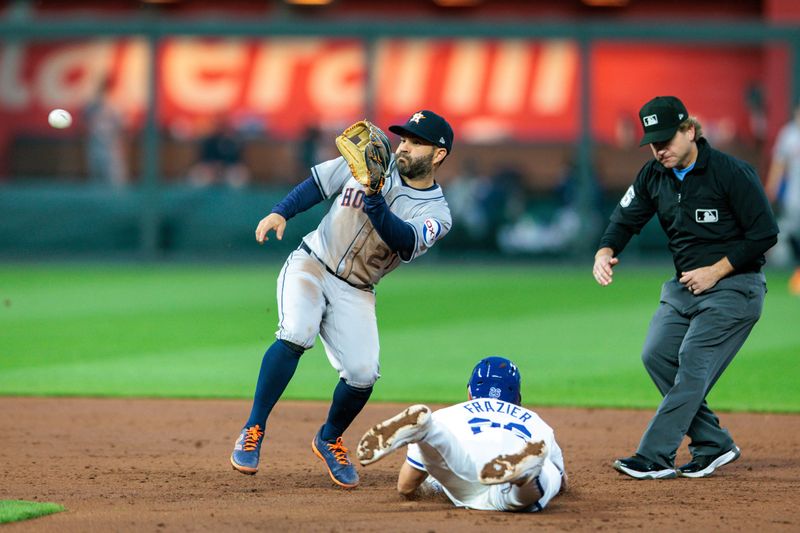 Apr 10, 2024; Kansas City, Missouri, USA; Houston Astros second base Jose Altuve (27) reaches for a throw to 2nd base as Kansas City Royals bench coach Paul Hoover (26) slides in during the third inning  for  at Kauffman Stadium. Mandatory Credit: William Purnell-USA TODAY Sports