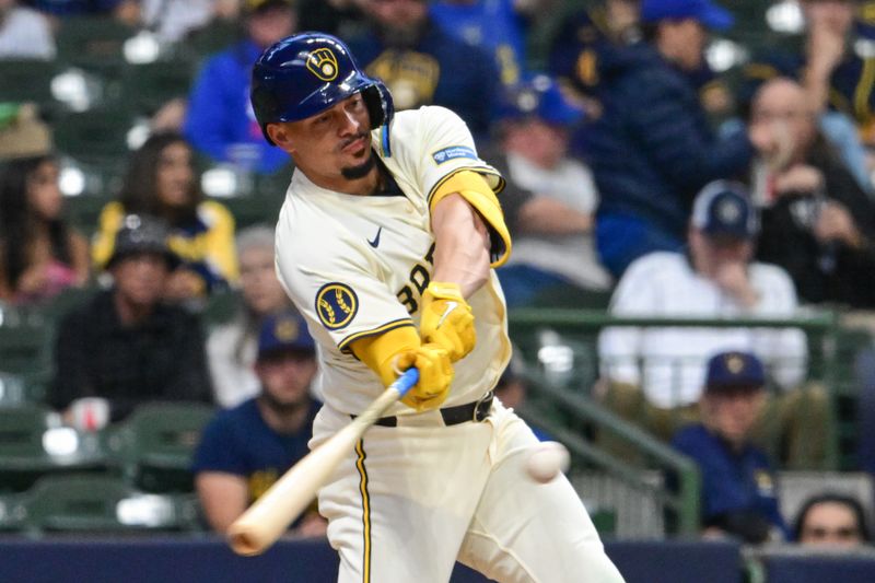 Apr 30, 2024; Milwaukee, Wisconsin, USA; Milwaukee Brewers shortstop Willy Adames (27) hits a sacrifice fly to drive in a run in the first inning against the Tampa Bay Rays at American Family Field. Mandatory Credit: Benny Sieu-USA TODAY Sports