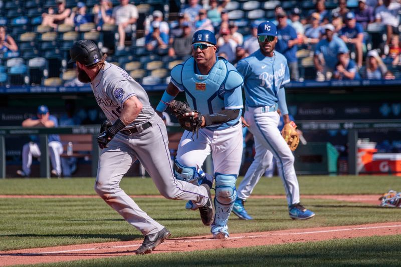 Jun 3, 2023; Kansas City, Missouri, USA; Kansas City Royals catcher Salvador Perez (13) gets Colorado Rockies designated hitter Charlie Blackmon (19) in a run-down during the sixth inning at Kauffman Stadium. Mandatory Credit: William Purnell-USA TODAY Sports