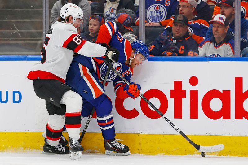 Jan 6, 2024; Edmonton, Alberta, CAN; Edmonton Oilers forward Connor McDavid (97) and Ottawa Senators defensemen Jake Sanderson (85) battle for a loose puck during the first period at Rogers Place. Mandatory Credit: Perry Nelson-USA TODAY Sports