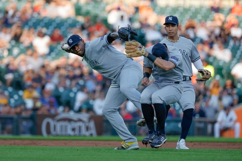 Aug 28, 2023; Detroit, Michigan, USA; New York Yankees starting pitcher Luis Severino (40) makes a throw to first as he avoids shortstop Anthony Volpe (11) and third baseman Gleyber Torres (25) in the second inning at Comerica Park. Mandatory Credit: Rick Osentoski-USA TODAY Sports