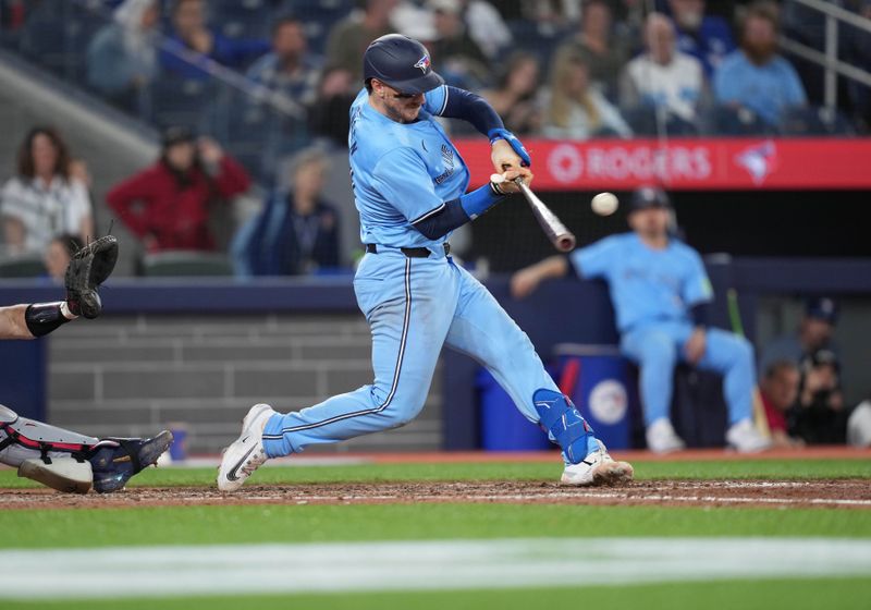 May 11, 2024; Toronto, Ontario, CAN; Toronto Blue Jays catcher Danny Jansen (9) hits a single against the Minnesota Twins during the eighth inning at Rogers Centre. Mandatory Credit: Nick Turchiaro-USA TODAY Sports