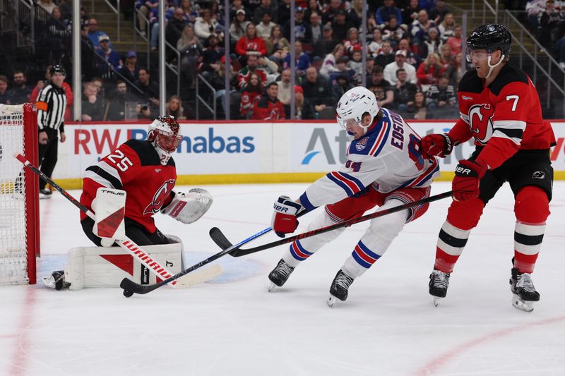 Mar 7, 2026; Newark, New Jersey, USA; New York Rangers center Adam Edstrom (84) takes a shot that is blocked by New Jersey Devils goaltender Jacob Markstrom (25) during the first period at Prudential Center. Mandatory Credit: Thomas Salus-Imagn Images