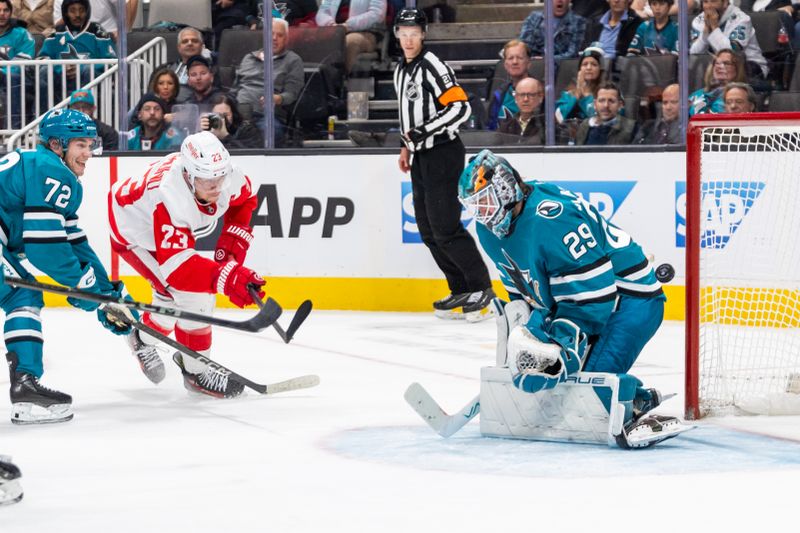 Nov 18, 2024; San Jose, California, USA; Detroit Red Wings left wing Lucas Raymond (23) shoots the puck past the net during overtime against the San Jose Sharks at SAP Center at San Jose. Mandatory Credit: Bob Kupbens-Imagn Images