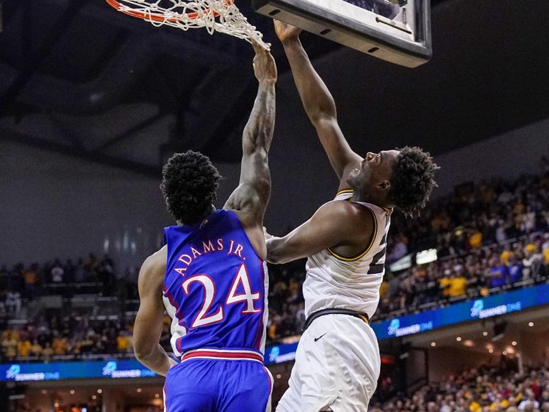 Dec 10, 2022; Columbia, Missouri, USA; Missouri Tigers guard Kobe Brown (24) shoots under the basket as Kansas Jayhawks forward K.J. Adams Jr. (24) defends during the first half at Mizzou Arena. Mandatory Credit: Denny Medley-USA TODAY Sports