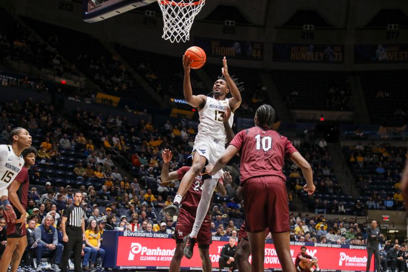 Dec 9, 2025; Morgantown, West Virginia, USA; West Virginia Mountaineers guard Chance Moore (13) shoots in the lane during the second half against the Little Rock Trojans at Hope Coliseum. Mandatory Credit: Ben Queen-Imagn Images