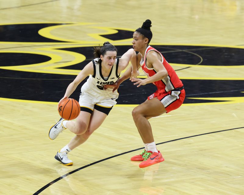 Mar 3, 2024; Iowa City, Iowa, USA; Ohio State Buckeyes guard Taylor Thierry (2) defends Iowa Hawkeyes guard Caitlin Clark (22) during the first half at Carver-Hawkeye Arena. Mandatory Credit: Reese Strickland-USA TODAY Sports