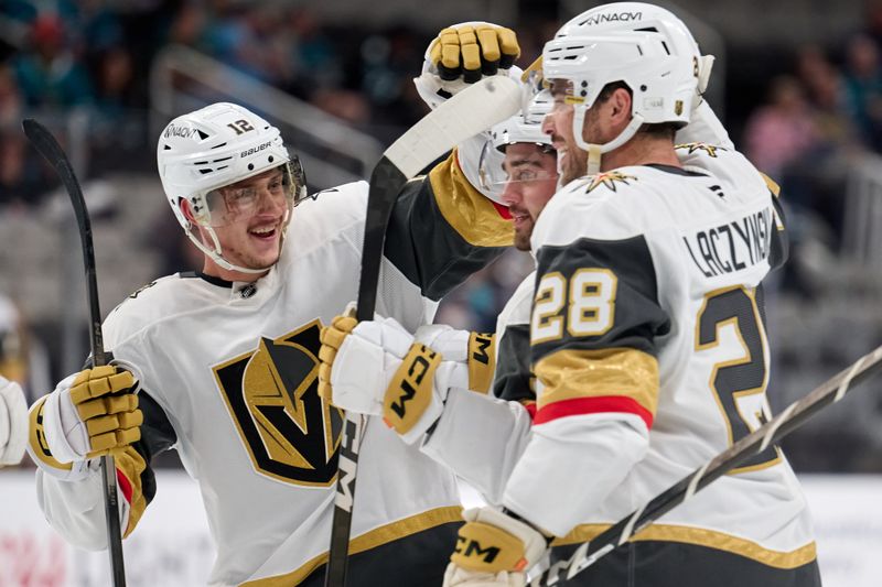 Sep 26, 2025; San Jose, California, USA; Vegas Golden Knights defenseman Lukas Cormier (51, center) celebrates with center Jakub Brabenec (12) and center Tanner Laczynski (28) after scoring the game-winning power play goal against the San Jose Sharks during the third period at SAP Center at San Jose. Mandatory Credit: Robert Edwards-Imagn Images