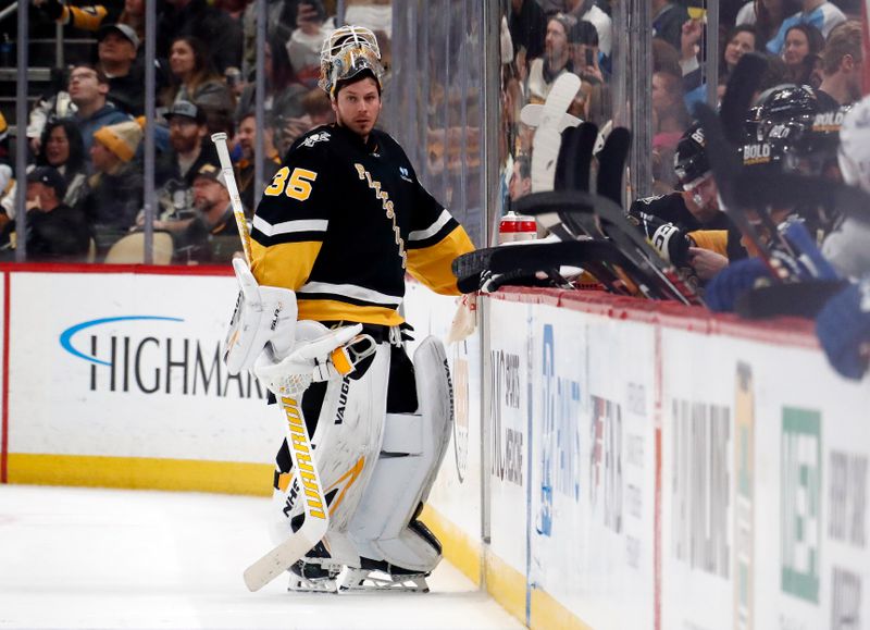 Jan 11, 2024; Pittsburgh, Pennsylvania, USA; Pittsburgh Penguins goaltender Tristan Jarry (35) talks to teammates on the Pens bench during a time-out against the Vancouver Canucks in the second period at PPG Paints Arena. The Canucks won 4-3 in overtime. Mandatory Credit: Charles LeClaire-USA TODAY Sports