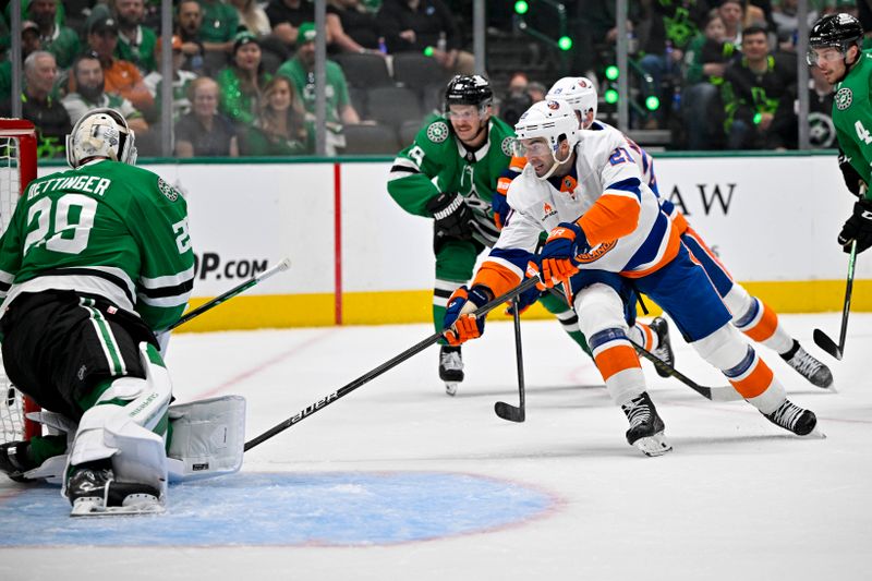 Oct 12, 2024; Dallas, Texas, USA; Dallas Stars goaltender Jake Oettinger (29) stops a shot by New York Islanders center Kyle Palmieri (21) during the first period at the American Airlines Center. Mandatory Credit: Jerome Miron-Imagn Images