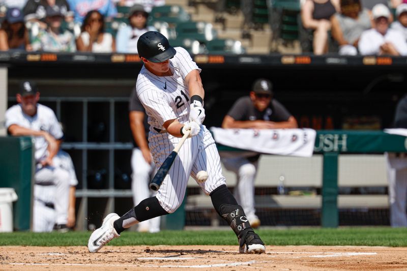 Sep 15, 2024; Chicago, Illinois, USA; Chicago White Sox first baseman Andrew Vaughn (21) hits an RBI-single against the Oakland Athletics during the first inning at Guaranteed Rate Field. Mandatory Credit: Kamil Krzaczynski-Imagn Images