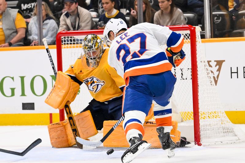 Jan 8, 2026; Nashville, Tennessee, USA; Nashville Predators goaltender Juuse Saros (74) blocks the shot of New York Islanders left wing Anders Lee (27) during the second period at Bridgestone Arena. Mandatory Credit: Steve Roberts-Imagn Images