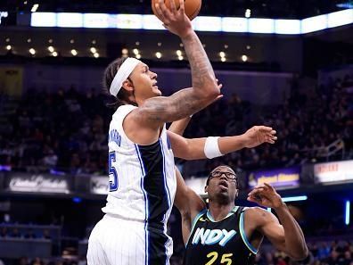 INDIANAPOLIS, INDIANA - DECEMBER 23: Paolo Banchero #5 of the Orlando Magic takes a shot over Jalen Smith #25 of the Indiana Pacers during the first half in the game at Gainbridge Fieldhouse on December 23, 2023 in Indianapolis, Indiana. NOTE TO USER: User expressly acknowledges and agrees that, by downloading and or using this photograph, User is consenting to the terms and conditions of the Getty Images License Agreement. (Photo by Justin Casterline/Getty Images)