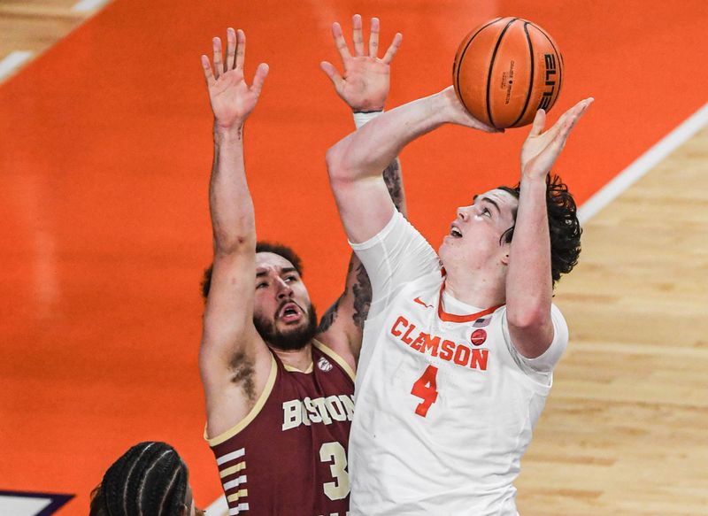 Jan 13, 2024; Clemson, South Carolina, USA; Clemson Tigers forward Ian Schieffelin (4) shoots the ball against Boston College Eagles forward Elijah Strong (31) during the first half at Littlejohn Coliseum. Mandatory Credit: Ken Ruinard-USA TODAY Sports