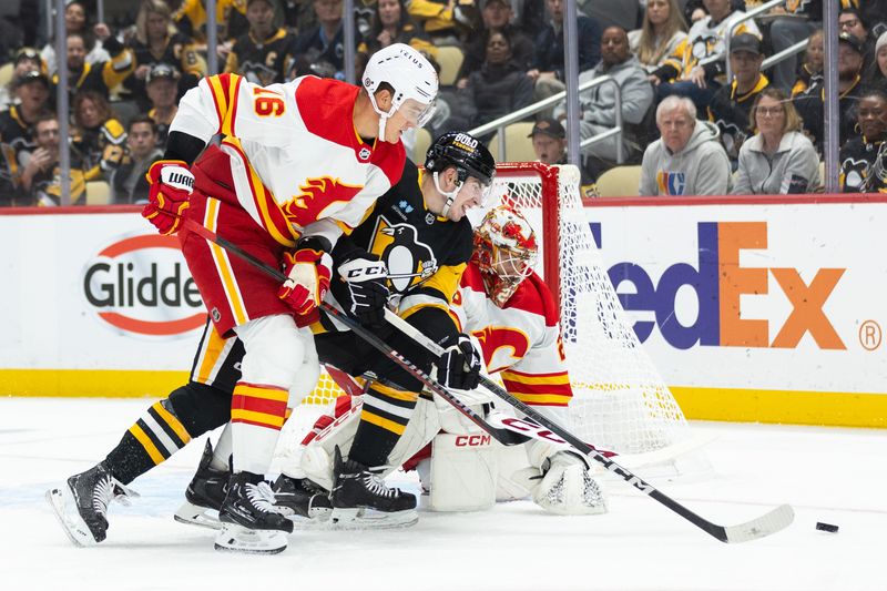 Oct 14, 2023; Pittsburgh, Pennsylvania, USA; Pittsburgh Penguins left winger Drew O'Connor (10) battles for the puck with Calgary Flames defenseman Nikita Zadorov (16) and goalie Jacob Markstrom (25) during the first period at PPG Paints Arena. Mandatory Credit: Scott Galvin-USA TODAY Sports