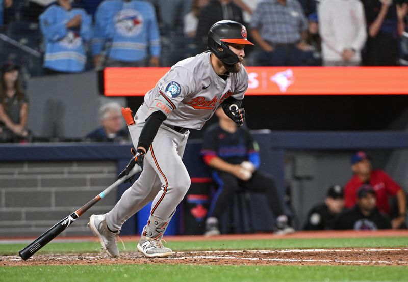 Aug 8, 2024; Toronto, Ontario, CAN; Baltimore Orioles left field Colton Cowser (17) hits a RBI double in the ninth inning against the Toronto Blue Jays at Rogers Centre. Mandatory Credit: Gerry Angus-USA TODAY Sports