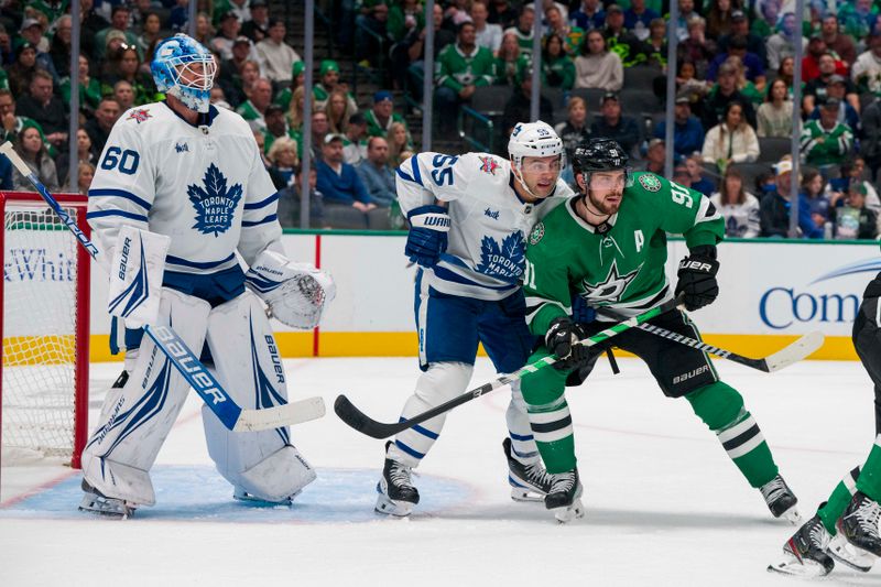 Oct 26, 2023; Dallas, Texas, USA; Dallas Stars center Tyler Seguin (91) and Toronto Maple Leafs defenseman Mark Giordano (55) battle for position in front of goaltender Joseph Woll (60) during the second period at the American Airlines Center. Mandatory Credit: Jerome Miron-USA TODAY Sports