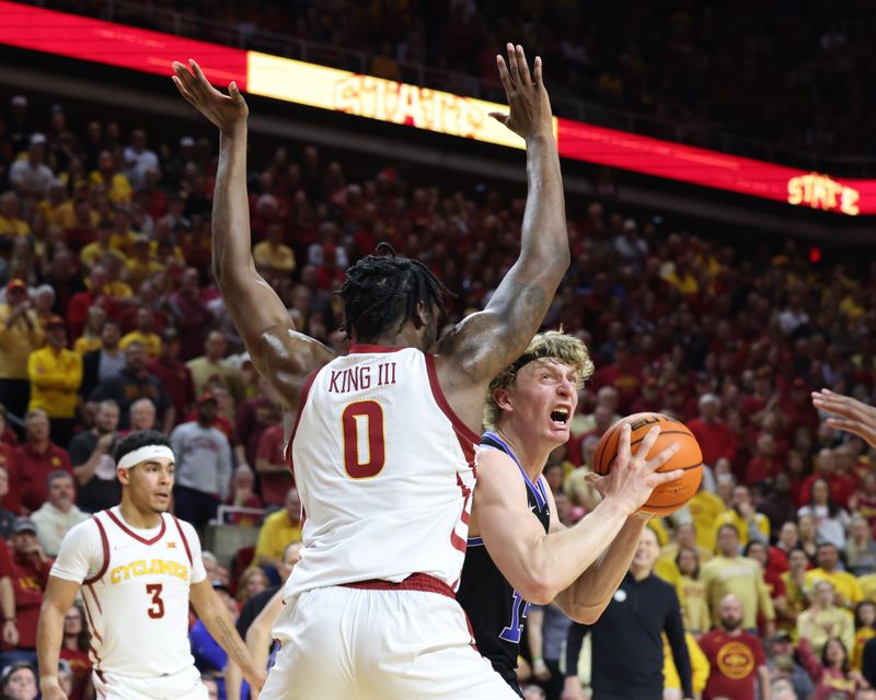 Mar 6, 2024; Ames, Iowa, USA; Iowa State Cyclones forward Tre King (0) defends Brigham Young Cougars guard Richie Saunders (15) in the second half at James H. Hilton Coliseum. Mandatory Credit: Reese Strickland-USA TODAY Sports
