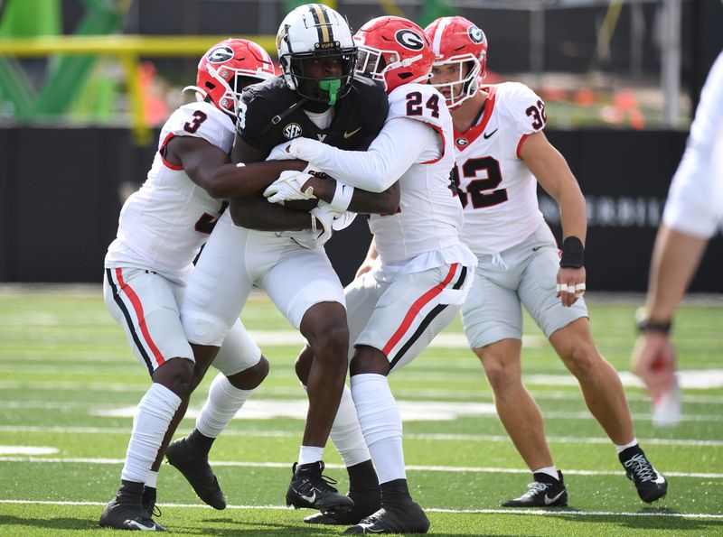 Oct 14, 2023; Nashville, Tennessee, USA; Vanderbilt Commodores wide receiver Quincy Skinner Jr. (3) is tackled by Georgia Bulldogs defensive back Kamari Lassiter (3) and defensive back Malaki Starks (24) during the first half at FirstBank Stadium. Mandatory Credit: Christopher Hanewinckel-USA TODAY Sports