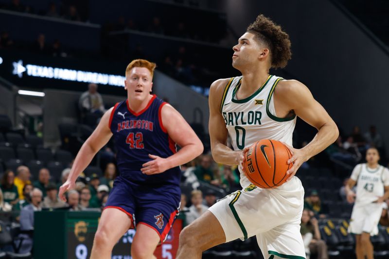 Dec 29, 2025; Waco, Texas, USA; Baylor Bears guard Dan Skillings Jr. (0) drives to the basket against Arlington Baptist Patriots guard Jacob Overbeck (42) during the first half at Paul and Alejandra Foster Pavilion. Mandatory Credit: Chris Jones-Imagn Images