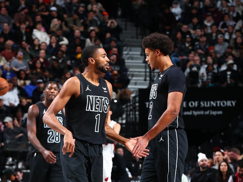 BROOKLYN, NY - JANUARY 15: Mikal Bridges #1 of the Brooklyn Nets high fives Cameron Johnson #2 of the Brooklyn Nets during the game against the Miami Heat on January 15, 2024 at Barclays Center in Brooklyn, New York. NOTE TO USER: User expressly acknowledges and agrees that, by downloading and or using this Photograph, user is consenting to the terms and conditions of the Getty Images License Agreement. Mandatory Copyright Notice: Copyright 2024 NBAE (Photo by David Nemec/NBAE via Getty Images)