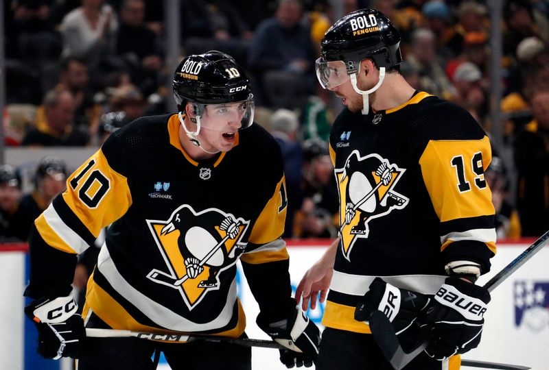 Feb 25, 2024; Pittsburgh, Pennsylvania, USA;  Pittsburgh Penguins left wing Drew O'Connor (10) and right wing Reilly Smith (19) talk on the ice against the Philadelphia Flyers during the third period at PPG Paints Arena.  Pittsburgh won 7-6. Mandatory Credit: Charles LeClaire-USA TODAY Sports