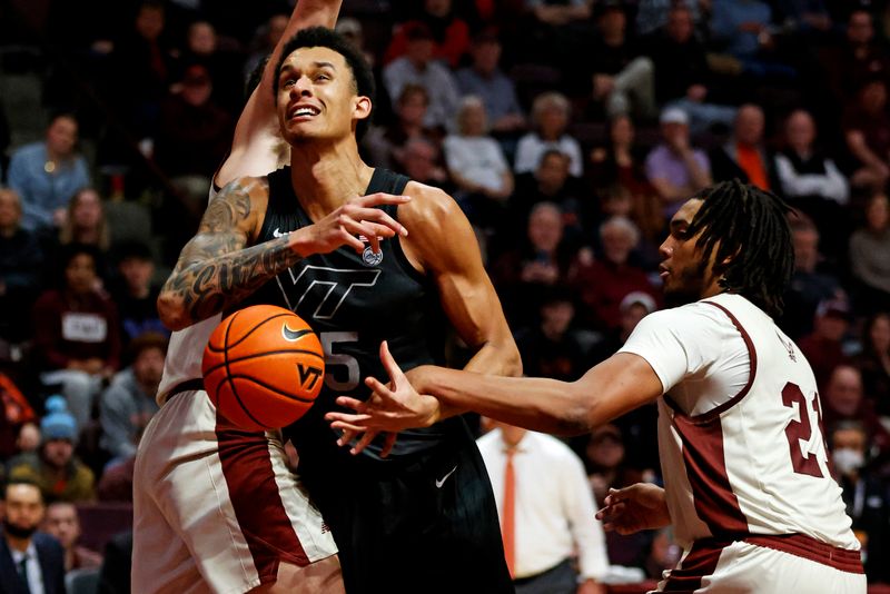 Jan 23, 2024; Blacksburg, Virginia, USA; Virginia Tech Hokies center Lynn Kidd (15) drives to the basket against Boston College Eagles forward Devin McGlockton (21) and forward Quinten Post (12) during the second half at Cassell Coliseum. Mandatory Credit: Peter Casey-USA TODAY Sports