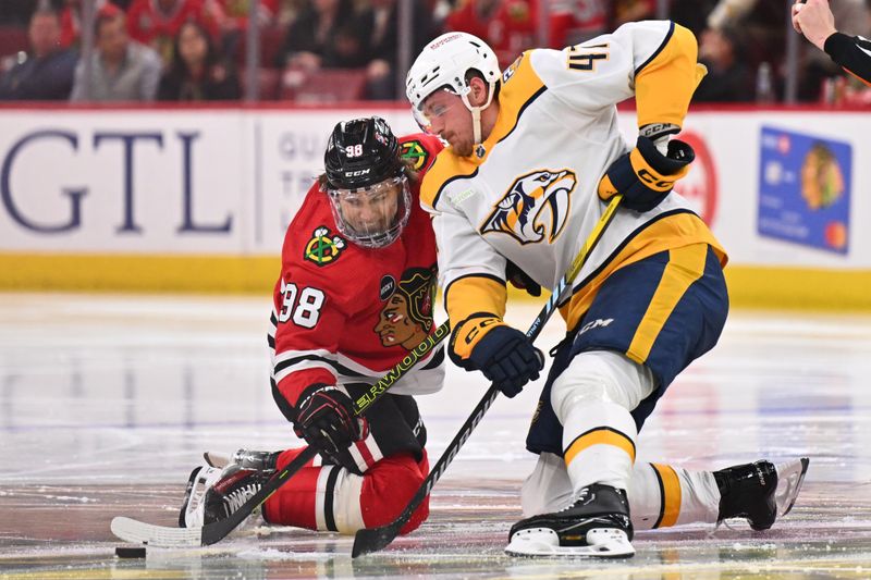 Apr 12, 2024; Chicago, Illinois, USA; Chicago Blackhawks forward Connor Bedard (98) and Nashville Predators forward Michael McCarron (47) battle for control of the face off in the second period at United Center. Mandatory Credit: Jamie Sabau-USA TODAY Sports