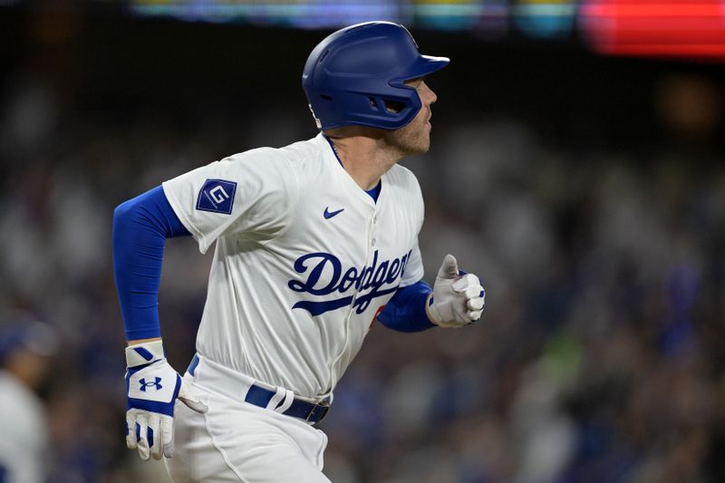 May 20, 2024; Los Angeles, California, USA;  Los Angeles Dodgers first baseman Freddie Freeman (5) hits a grand slam home run in the third inning against the Arizona Diamondbacks at Dodger Stadium. Mandatory Credit: Jayne Kamin-Oncea-USA TODAY Sports