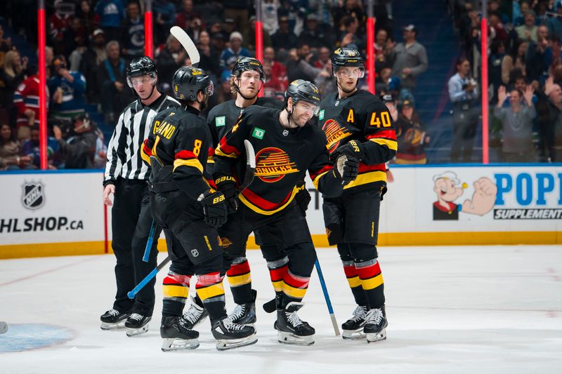 Oct 25, 2025; Vancouver, British Columbia, CAN; Vancouver Canucks forward Conor Garland (8) and forward Jake DeBrusk (74) and forward Brock Boeser (6) and forward Elias Pettersson (40) celebrate DeBrusk’s goal against the Montreal Canadiens in the second period at Rogers Arena. Mandatory Credit: Bob Frid-Imagn Images