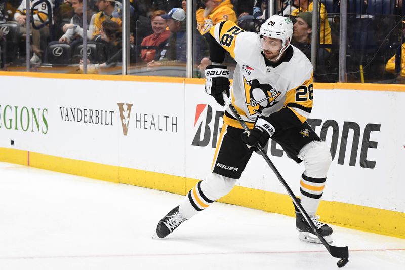 Nov 28, 2023; Nashville, Tennessee, USA; Pittsburgh Penguins defenseman Marcus Pettersson (28) looks to pass the puck during the first period against the Nashville Predators at Bridgestone Arena. Mandatory Credit: Christopher Hanewinckel-USA TODAY Sports