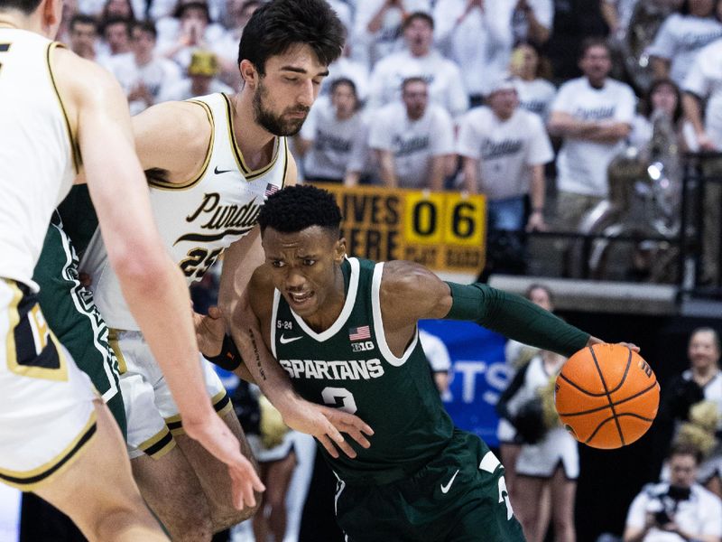 Jan 29, 2023; West Lafayette, Indiana, USA;  Michigan State Spartans guard Tyson Walker (2) dribbles the ball while Purdue Boilermakers guard Ethan Morton (25) defends in the first half at Mackey Arena. Mandatory Credit: Trevor Ruszkowski-USA TODAY Sports