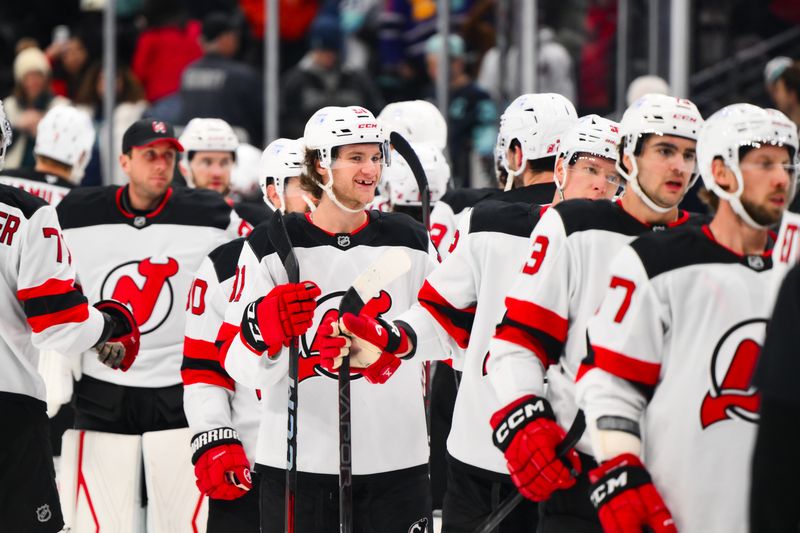 Jan 6, 2025; Seattle, Washington, USA; The New Jersey Devils celebrate after defeating the Seattle Kraken third period at Climate Pledge Arena. Mandatory Credit: Steven Bisig-Imagn Images