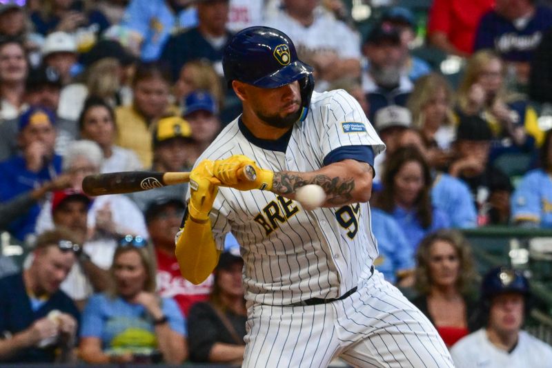 Aug 10, 2024; Milwaukee, Wisconsin, USA; Milwaukee Brewers designated hitter Gary Sanchez (99) is hit by a pitch in the seventh inning against the Cincinnati Reds at American Family Field. Mandatory Credit: Benny Sieu-USA TODAY Sports