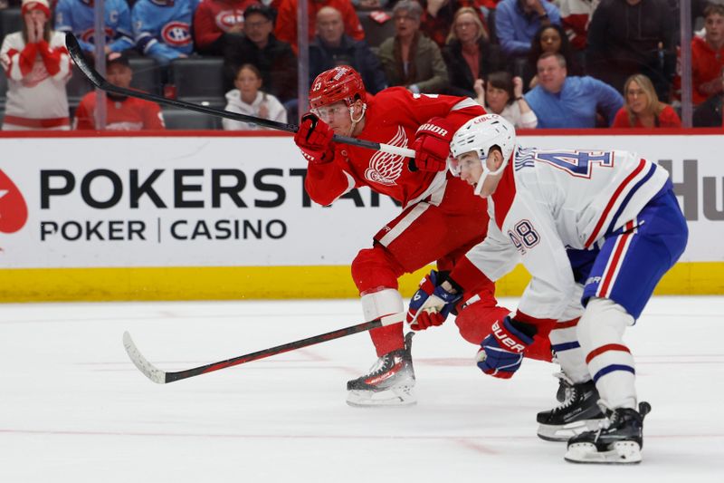 Apr 15, 2024; Detroit, Michigan, USA;  Detroit Red Wings left wing Lucas Raymond (23) takes a shot and scores in overtime against the Montreal Canadiens at Little Caesars Arena. Mandatory Credit: Rick Osentoski-USA TODAY Sports