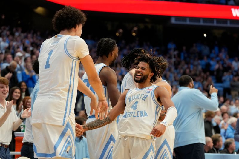 Jan 22, 2024; Chapel Hill, North Carolina, USA;  North Carolina Tar Heels guard RJ Davis (4) reacts with forward Zayden High (1) late in the second half at Dean E. Smith Center. Mandatory Credit: Bob Donnan-USA TODAY Sports