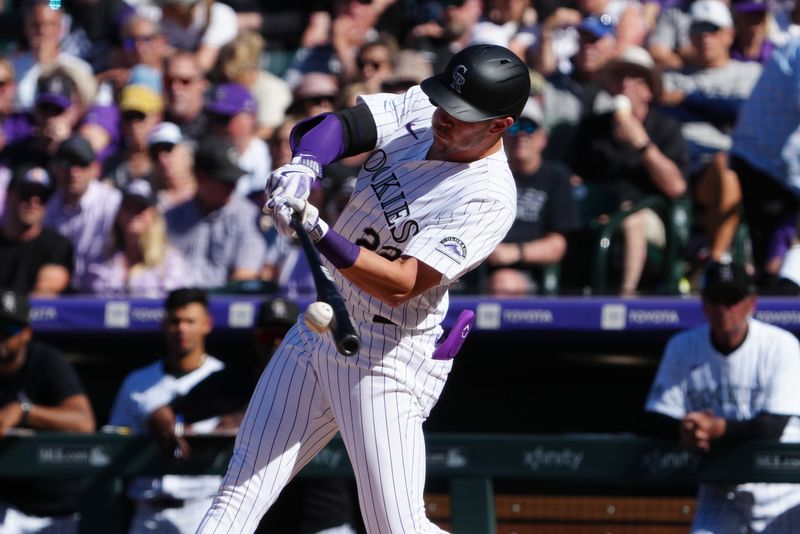 Apr 5, 2024; Denver, Colorado, USA;  Colorado Rockies outfielder Nolan Jones (22) singles in the sixth inning against the Tampa Bay Rays at Coors Field. Mandatory Credit: Ron Chenoy-USA TODAY Sports