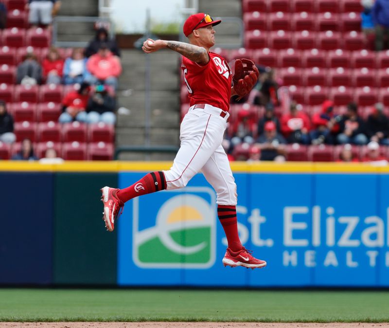 Apr 16, 2023; Cincinnati, Ohio, USA; Cincinnati Reds second baseman Nick Senzel (15) throws to first base for the out against the Philadelphia Phillies during the seventh inning at Great American Ball Park. Mandatory Credit: David Kohl-USA TODAY Sports