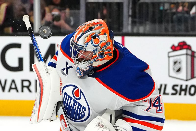 Dec 3, 2024; Las Vegas, Nevada, USA; Edmonton Oilers goaltender Stuart Skinner (74) makes a save against the Vegas Golden Knights during the second period at T-Mobile Arena. Mandatory Credit: Stephen R. Sylvanie-Imagn Images