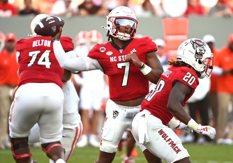 Oct 28, 2023; Raleigh, North Carolina, USA; North Carolina State Wolfpack quarterback MJ Morris (7) throws a pass during the second half against the Clemson Tigers at Carter-Finley Stadium. Mandatory Credit: Rob Kinnan-USA TODAY Sports