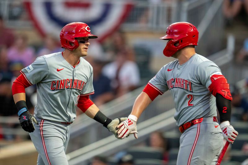 Sep 13, 2024; Minneapolis, Minnesota, USA; Cincinnati Reds center fielder TJ Friedl (29) celebrates with first baseman Ty France (2) after hitting a solo home run against the Minnesota Twins in the second inning at Target Field. Mandatory Credit: Jesse Johnson-Imagn Images