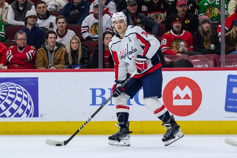 Dec 10, 2023; Chicago, Illinois, USA; Washington Capitals defenseman John Carlson (74) plays the puck against the Chicago Blackhawks during the first period at the United Center. Mandatory Credit: Daniel Bartel-USA TODAY Sports