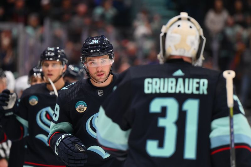 Feb 22, 2024; Seattle, Washington, USA; Seattle Kraken defenseman Vince Dunn (29) celebrates with goaltender Philipp Grubauer (31) after scoring a goal against the Vancouver Canucks during the first period at Climate Pledge Arena. Mandatory Credit: Steven Bisig-USA TODAY Sports