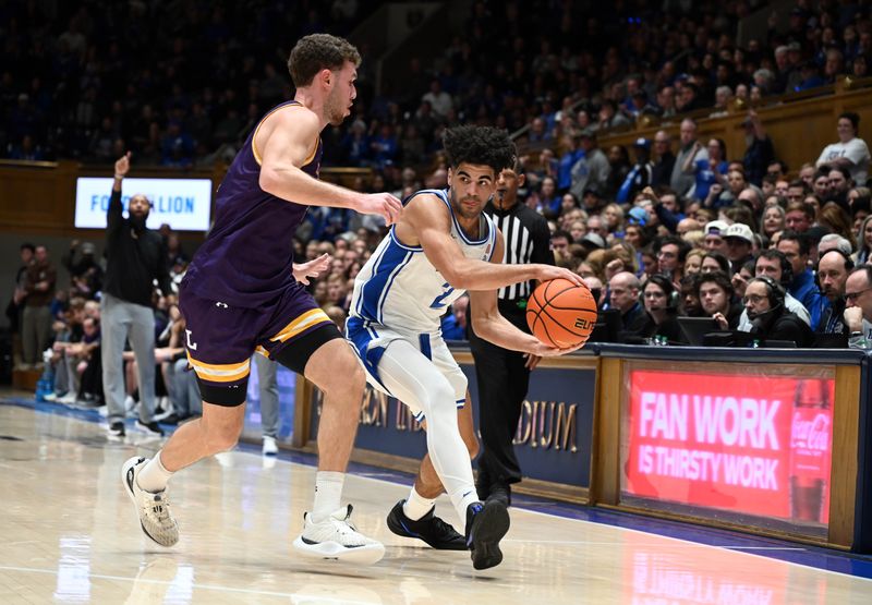 Dec 16, 2025; Durham, North Carolina, USA;  Duke Blue Devils guard Cayden Boozer (2) throws a pass around Lipscomb Bisons forward Kellan Boyland (23) during the second half at Cameron Indoor Stadium. The Blue Devils won 97-73.  Mandatory Credit: Rob Kinnan-Imagn Images