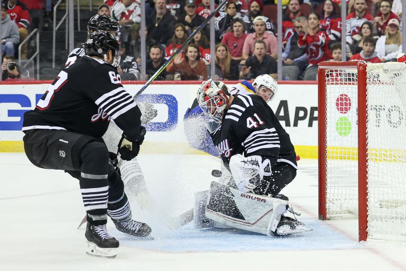 Oct 27, 2023; Newark, New Jersey, USA; New Jersey Devils goaltender Vitek Vanecek (41) makes a save in front of defenseman Kevin Bahl (88) during the second period against Buffalo Sabres left wing Victor Olofsson (71) at Prudential Center. Mandatory Credit: Vincent Carchietta-USA TODAY Sports