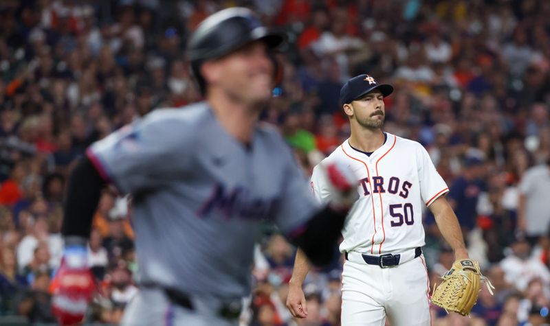 Jul 11, 2024; Houston, Texas, USA; Houston Astros relief pitcher Tayler Scott (50) reacts as Miami Marlins catcher Nick Fortes (4) runs down the first base line before being thrown out with men in scoring position to end the top of the sixth inning at Minute Maid Park. Mandatory Credit: Thomas Shea-USA TODAY Sports