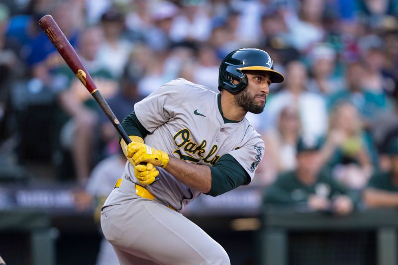 May 11, 2024; Seattle, Washington, USA; Oakland Athletics second baseman Abraham Toro (31) hits a RBI-single during the third inning against the Seattle Mariners at T-Mobile Park. Mandatory Credit: Stephen Brashear-USA TODAY Sports