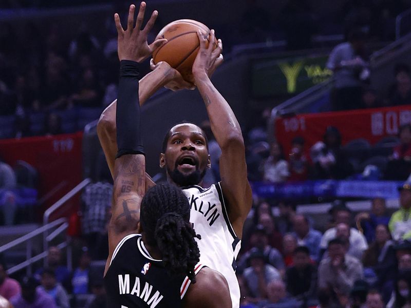 LOS ANGELES, CALIFORNIA - NOVEMBER 12:  Kevin Durant #7 of the Brooklyn Nets takes a shot against Terance Mann #14 of the LA Clippers in the first half at Crypto.com Arena on November 12, 2022 in Los Angeles, California.  NOTE TO USER: User expressly acknowledges and agrees that, by downloading and/or using this photograph, user is consenting to the terms and conditions of the Getty Images License Agreement.  (Photo by Ronald Martinez/Getty Images)