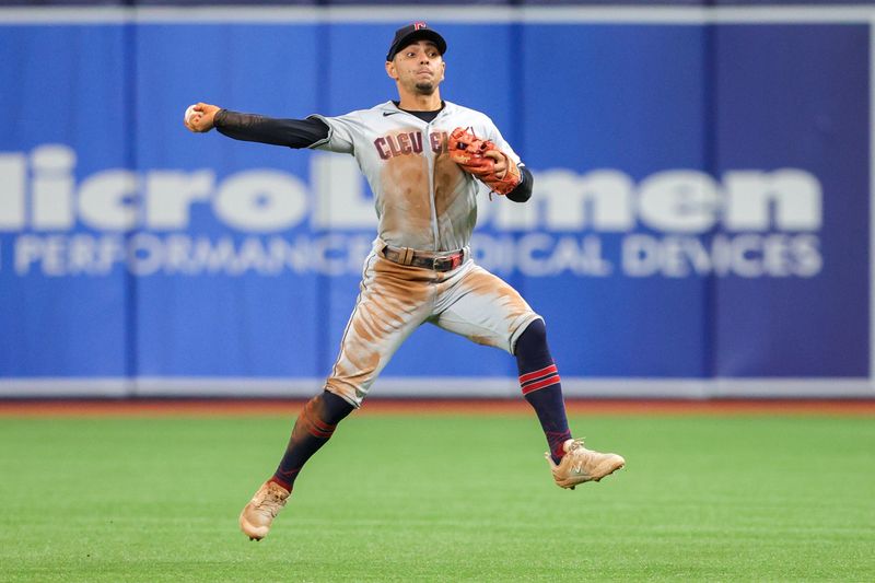 Aug 13, 2023; St. Petersburg, Florida, USA;  Cleveland Guardians second baseman Andres Gimenez (0) throws to first for an out against the Tampa Bay Rays in the seventh inning at Tropicana Field. Mandatory Credit: Nathan Ray Seebeck-USA TODAY Sports